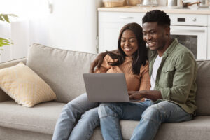 loving-black-couple-using-laptop-together-home-in-2022-01-05-03-48-35-WZLL63Y.jpg